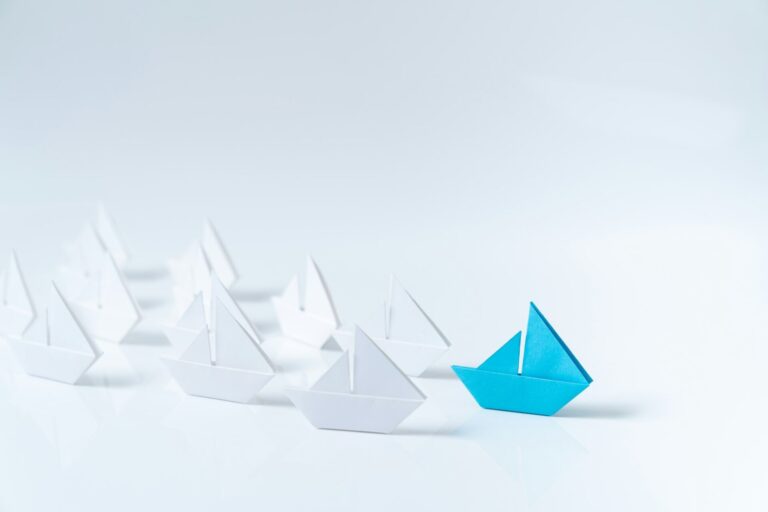 Leadership conceptual using blue paper ship